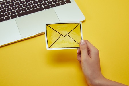 Cropped image of woman holding message sign near laptop Stock Photo