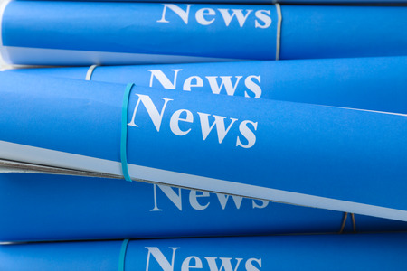 Rolls of paper with words news closeup Stock Photo
