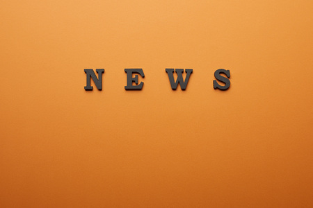 Top view of news lettering with copy space on orange Stock Photo