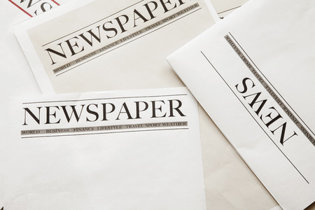 Reading newspaper on background