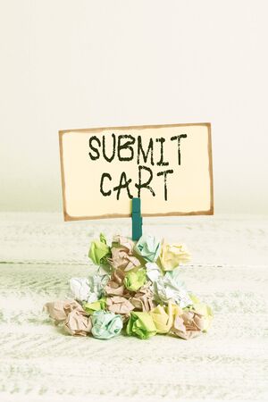 Writing note showing submit cart business concept for sending shopping list of online items proceed checkout reminder pile colored crumpled paper clothespin wooden space