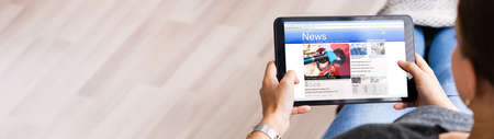 Watching news on tablet computer screen online