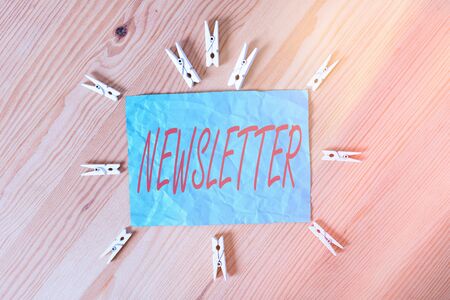 Word writing text newsletter business photo showcasing the bulletin was given to members of a company regularly colored clothespin papers empty reminder wooden floor background office