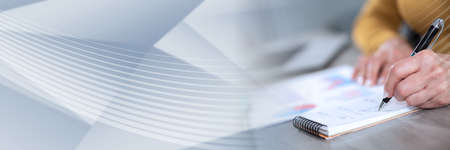 Businesswoman analyzing marketing data and taking notes panoramic banner Stock Photo