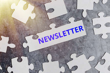 Text sign showing newsletter business approach the bulletin was given to members of a company regularly building an unfinished white jigsaw pattern puzzle with missing last piece Stock Photo