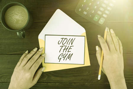 Conceptual display join the gym business showcase motivation to start working out making exercises fitness woman with blank letter coffee and stationery over wooden table