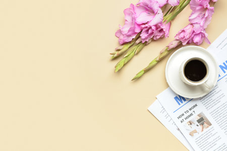 Beautiful gladiolus flowers cup of coffee and newspaper on color background closeup Stock Photo