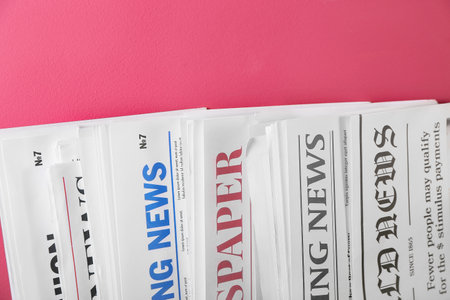 Different newspapers on color background Stock Photo