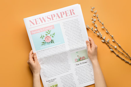 Woman with newspaper and willow branches on color background