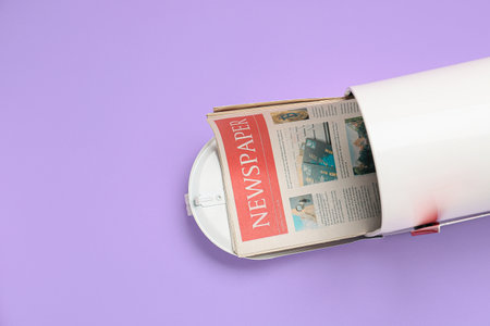 Mail box with newspaper on color background Stock Photo