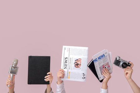 Female hands with newspapers notebooks microphone and photo camera on color background
