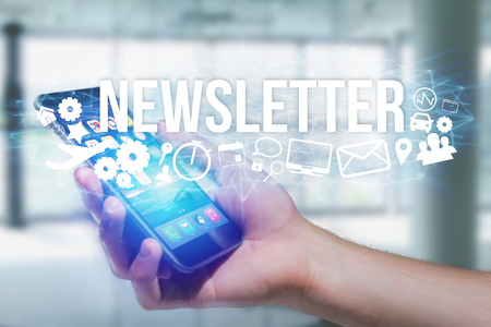 Concept view of man holding futuristic interface with newsletter title and multimedia icons flying all around internet concept