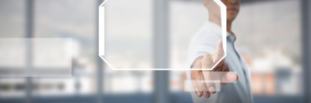 Man pretending to touch an invisible screen against white background against buildings and mountain seen through glass in office Stock Photo